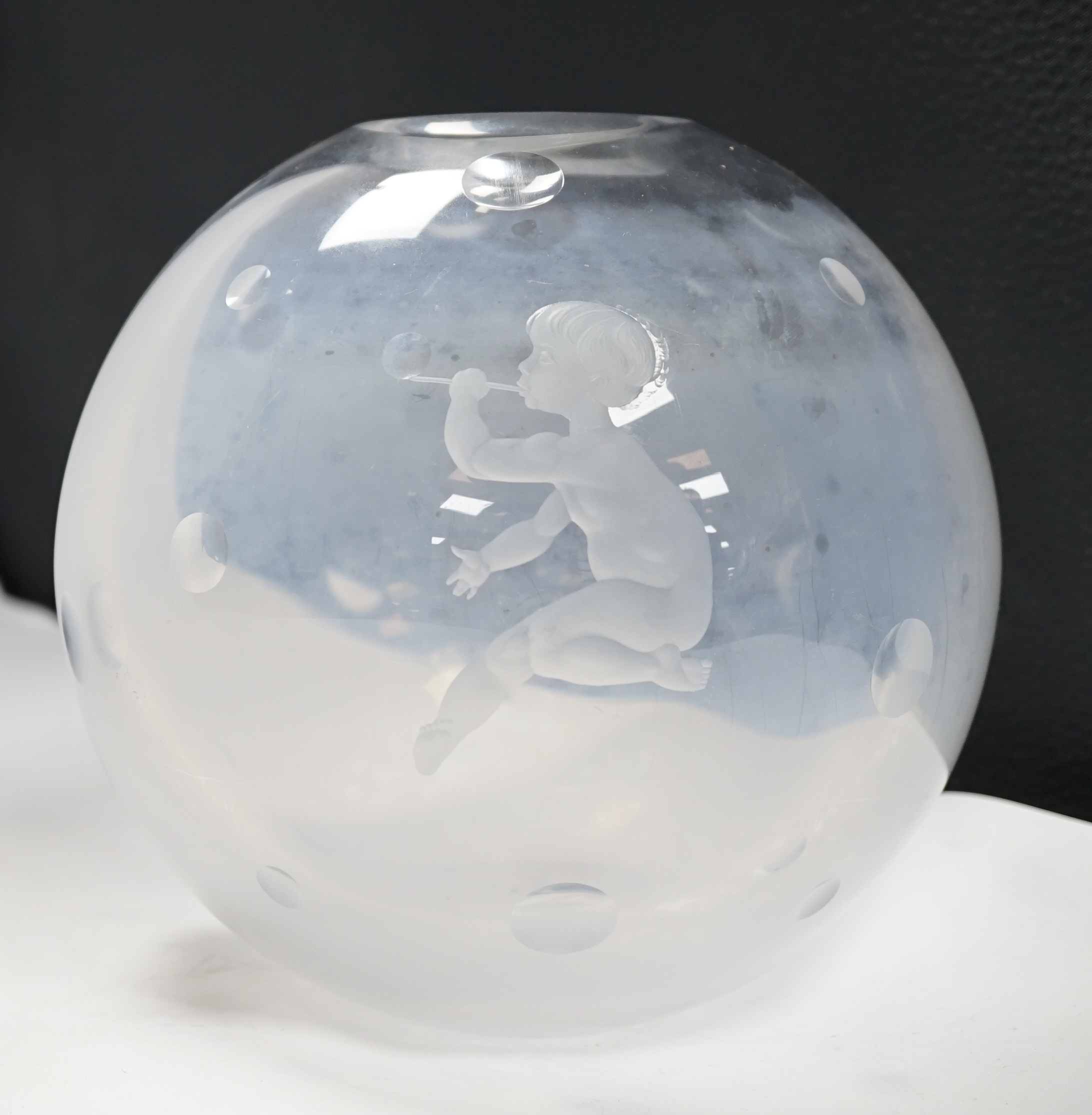 An Orrefors globular glass vase, engraved with a boy blowing bubbles, attributed to Vicke Lindstrand, indistinctly signed on worn base, 19cm high